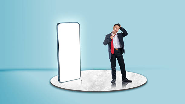 istock A businessman with a tired expression loosened his tie standing with a blank mobile phone screen. Copy space or mockup. Concept of business 2203158664