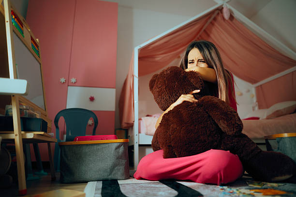 Sad Mother Crying Holding a Teddy Bear Toy Feeling Devastated