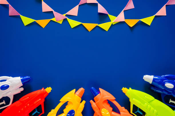 istock Water guns put on blue background with party flags 2203158967