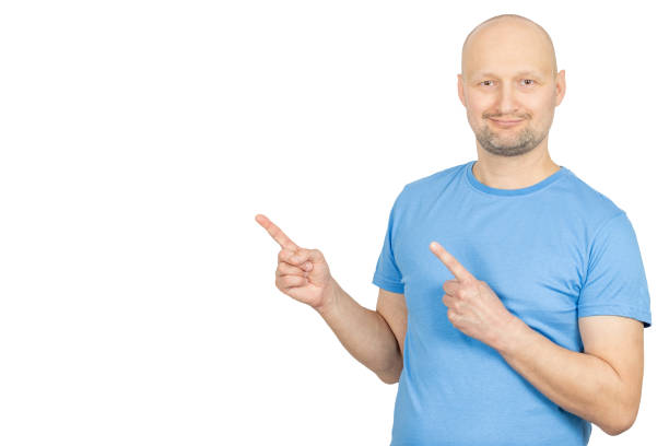 Studio shot of a man pointing his index fingers to the sides, suggesting two options or directions