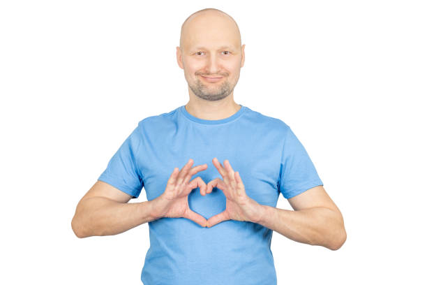 istock Smiling bald man showing heart sign with hands on white background 2203159605
