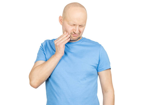 istock Man suffering from strong toothache touching his cheek with hand 2203159662