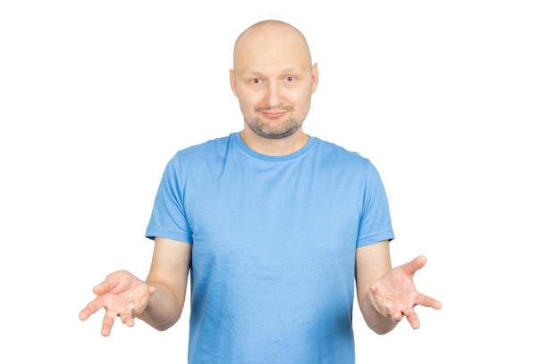 istock Bald man showing empty hands with open palms, shrugging shoulders, uncertain facial expression 2203159769