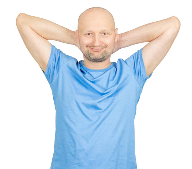 istock Bald man relaxing with hands behind head, smiling and feeling good 2203159781