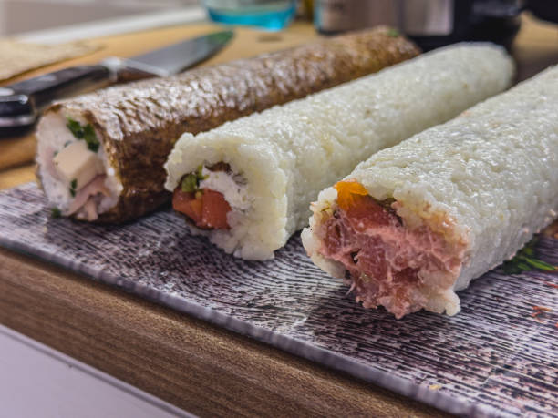 istock Sushi rolls prepared on a wooden kitchen counter in a cozy home setting 2203160778
