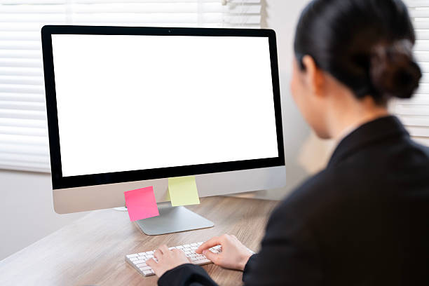 istock Businesswoman working empty screen computer on wood desk in office. 2203161321