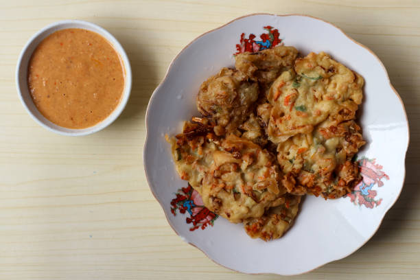 istock Fried bakwan served with peanut sauce on a wooden table 2203164505
