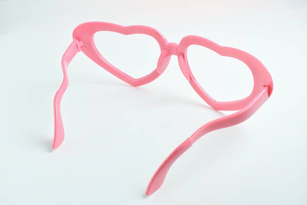 istock pink heart shape of glasses on white background 2203165121