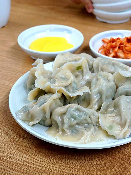 Steamed or fried Korean mandu dumplings filled with a savory mix of meat and vegetables. Crispy on the outside, tender on the inside—perfect for dipping in soy sauce or chili oil!
