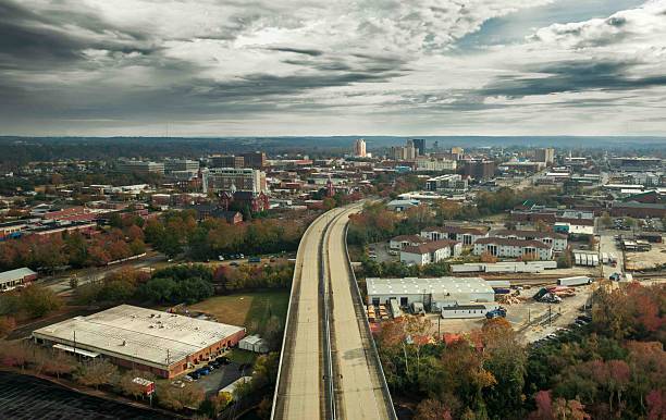 istock Aerial cityscape with highway and dramatic sky. 2203173559