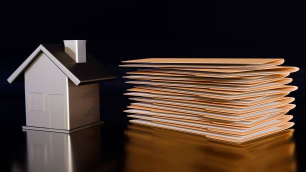 istock A miniature house with a stack of manila file folders 2203174823