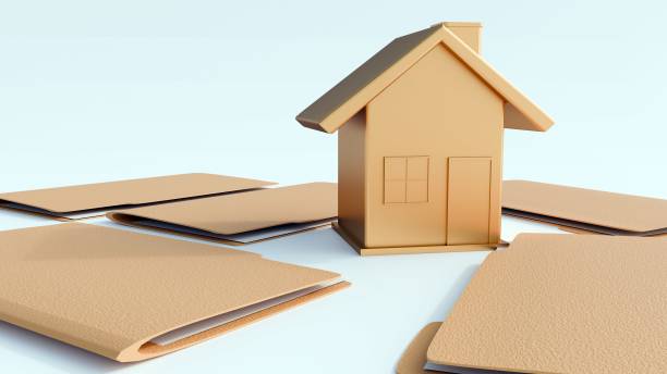 istock A miniature house with a stack of manila file folders 2203174824