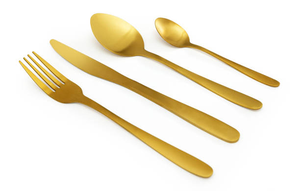 istock Golden cutlery set lying on white background 2203174841