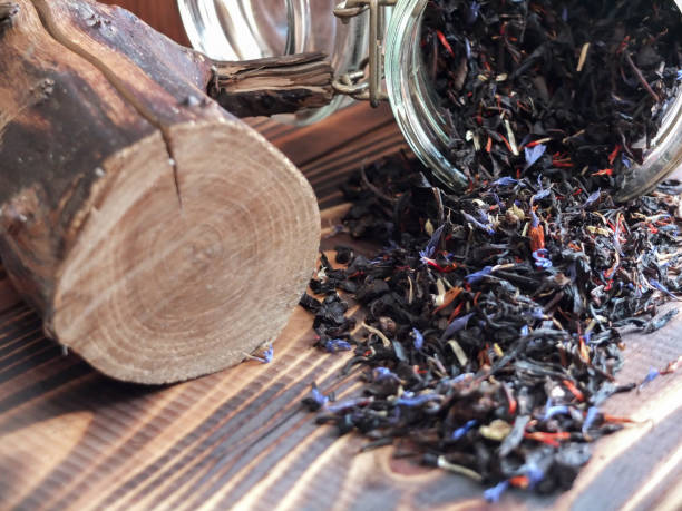 istock Scattered tea from a jar on a wooden background 2203176600