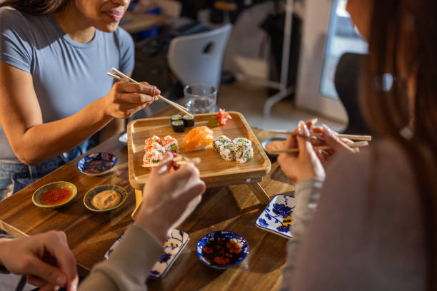 istock Young friends in sushi bar 2203177868