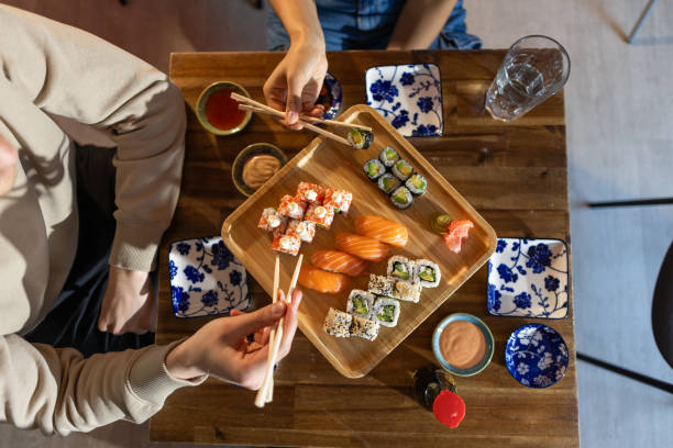 istock Young couple dating in sushi bar 2203178103
