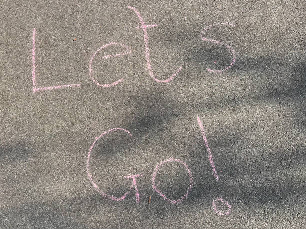 A motivational message on the sidewalk in chalk, saying Lets go a great visual for promoting physical activity, fun, and healthy habits for kids.