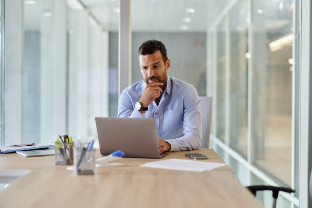 istock Thoughtful male entrepreneur working on laptop in the office. 2203185248