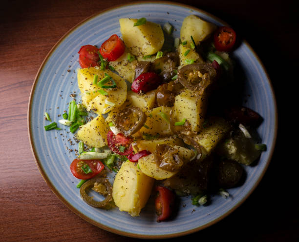 istock Delightful boiled potatoes garnished with spices, fresh cherry tomatoes, and vibrant hot peppers for a burst of flavor 2203186272