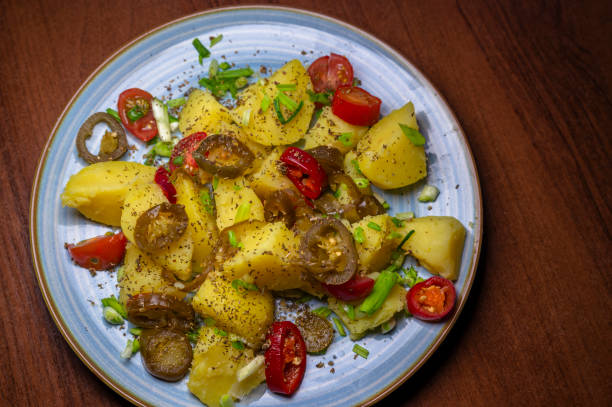 istock Deliciously seasoned boiled potatoes adorned with vibrant cherry tomatoes and fresh spring onions 2203186351