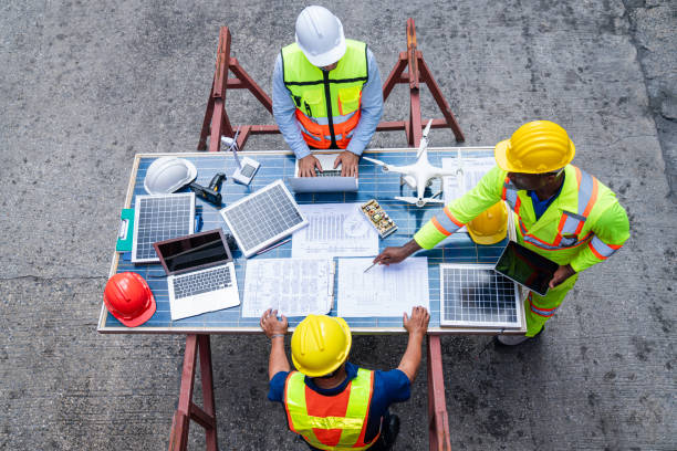 istock Portrait of team engineer working on solar panel and his blueprints 2203186737