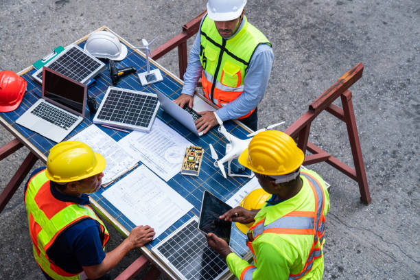 istock Portrait of team engineer working on solar panel and his blueprints 2203186743