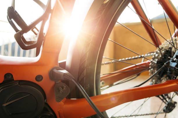 istock Close-Up of Electric Bicycle With Charging Cable and Sunlight 2203189836
