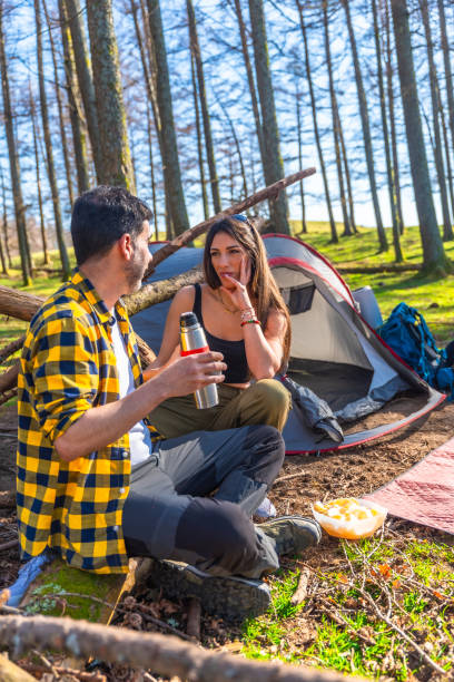 istock Hikers relaxing and chatting at their campsite in a forest 2203191349