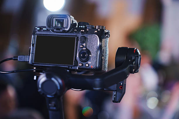 istock Camera setup on stabilizer at a lively indoor event with soft lighting 2203191517