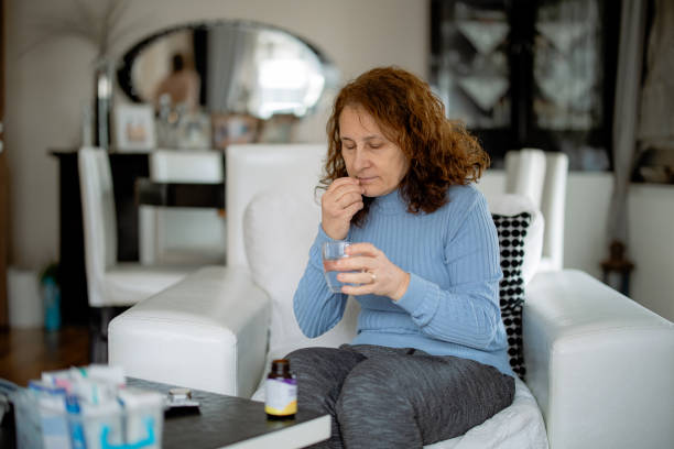istock Latin woman checking patient information leaflet for her medicine. 2203192673