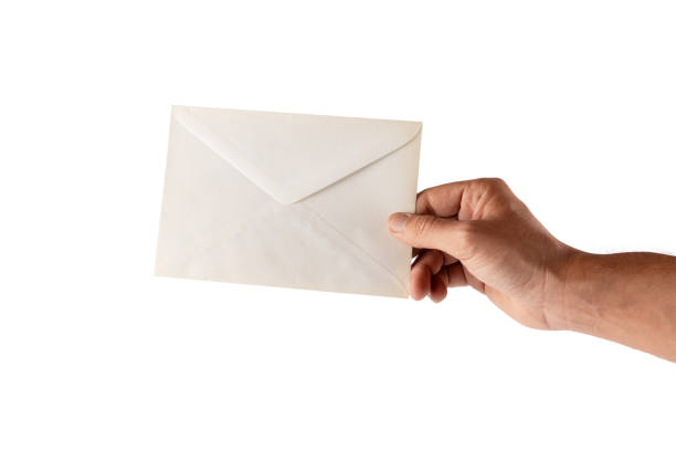 Male hand holding a white envelope isolated on white background. High quality photo