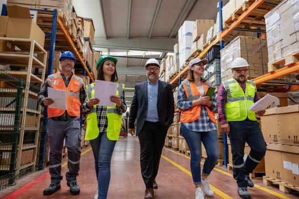 istock Collaborative Innovation: Brainstorming and Discussion in Factory Warehouse Corridor 2203196840