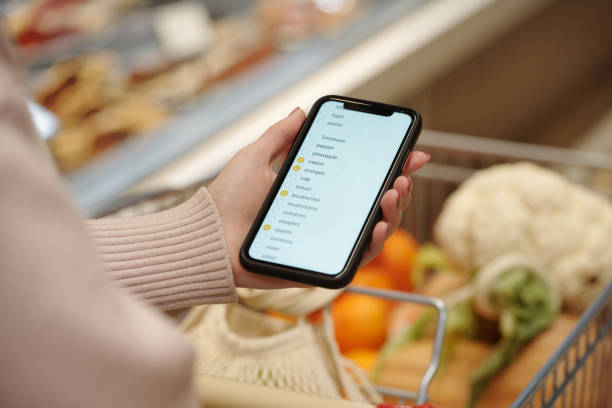 istock Woman Holding Smartphone With Shopping List 2203198713