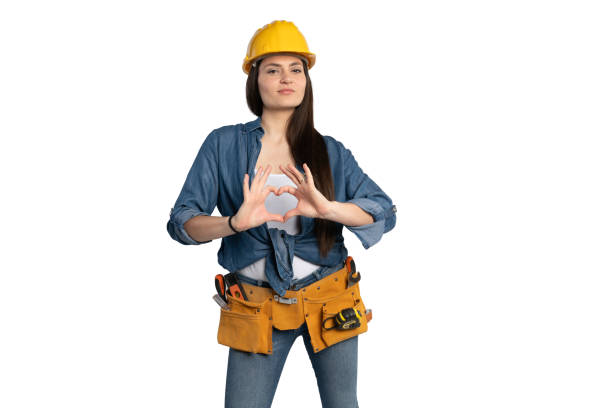 istock Female Construction Worker Making a Heart Symbol with Hands 2203202333