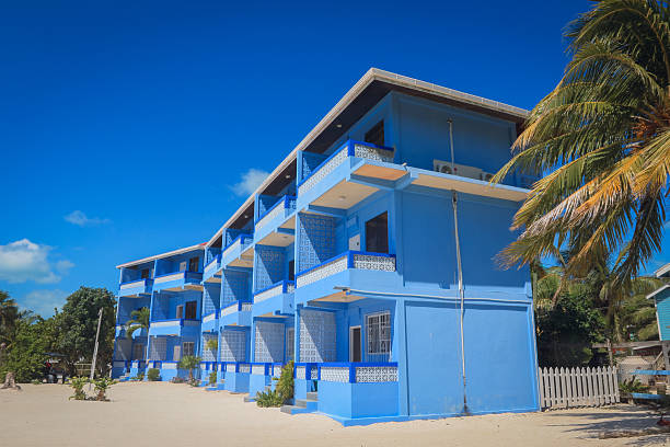 istock Colorful blue building on Caye Caulker beach with clear blue sky in Belize 2203202513