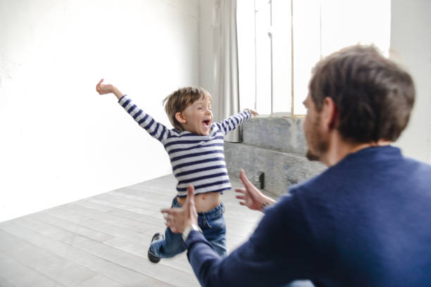 istock father waiting the son with arm raised 2203203159