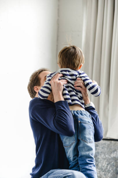 istock father waiting the son with arm raised 2203203566