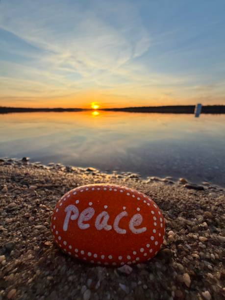 istock a beautiful orange painted peace stone on beach in sunset light in spring season 2203203567