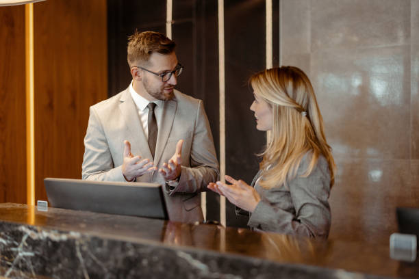 istock Hotel Manager Providing Instructions to Front Desk Employee 2203204037