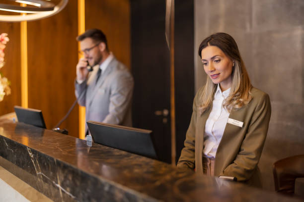 istock Lobby Efficiency: Hotel Concierge and Receptionist Delivering Top-Notch Service 2203205069