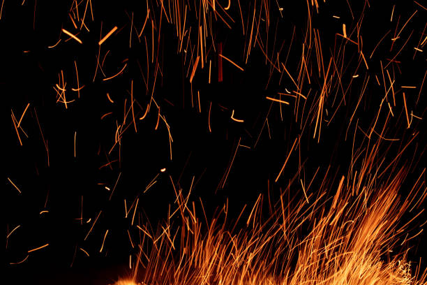istock sparks from the fire glowing in the dark 2203205944