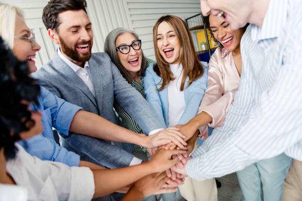 istock Diverse group of coworkers collaborating happily in a modern office environment, multi-age 2203206882