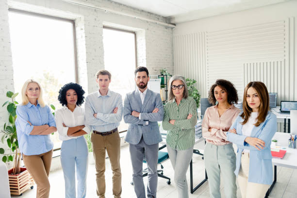 istock Group of diverse professionals standing confidently in an office workspace, conveying teamwork, productivity, and collaboration 2203206888