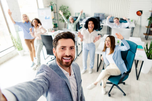 istock Cheerful team posing together in a modern office setting, showcasing unity and positive work atmosphere 2203206891