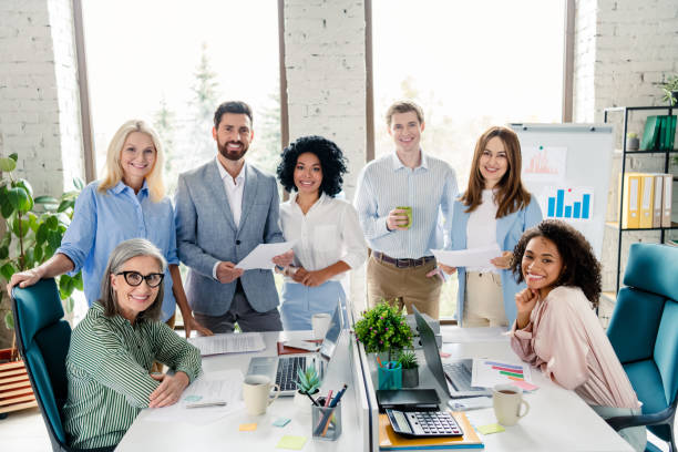 istock Diverse business team collaborating in modern office setting with paperwork and data charts 2203206935