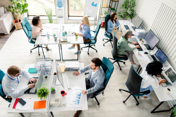 istock Professional team collaborating in a modern coworking space with daylight atmosphere, top view 2203206973