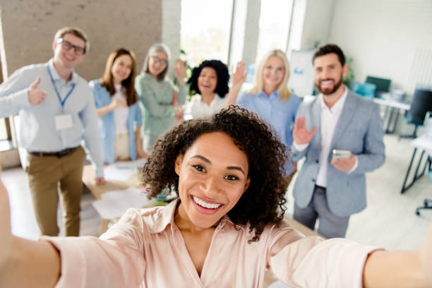 istock Cheerful Office Team Taking a Group Selfie in Professional Environment 2203207017