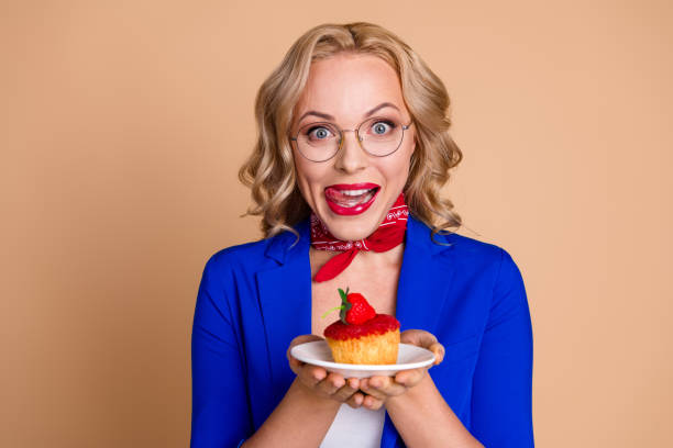 istock Woman in blue blazer posing on beige background with excited expression demonstrating her cheerful spirit 2203211143