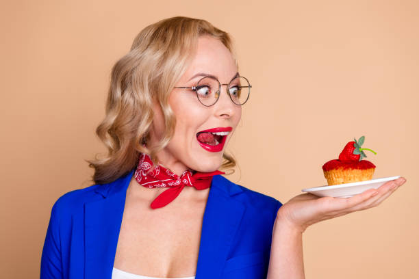 istock Woman in blue blazer posing on beige background with excited expression demonstrating her cheerful spirit 2203211146