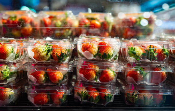 istock Plastic boxes with fresh strawberries for sale in a supermarket 2203212070